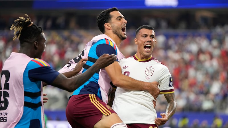 Spain's Pedro Porro, right, celebrates with Mikel Merino and Nico Williams, left, after...