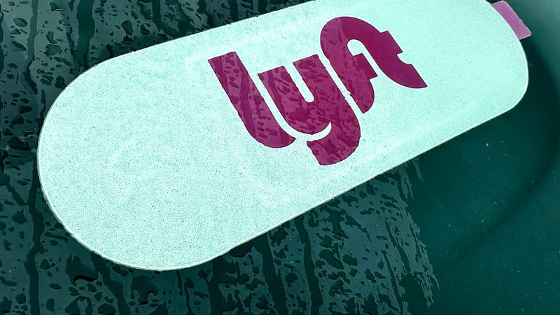 A Lyft sign is displayed inside a car in Vernon Hills, Ill., Tuesday, April 2, 2024.