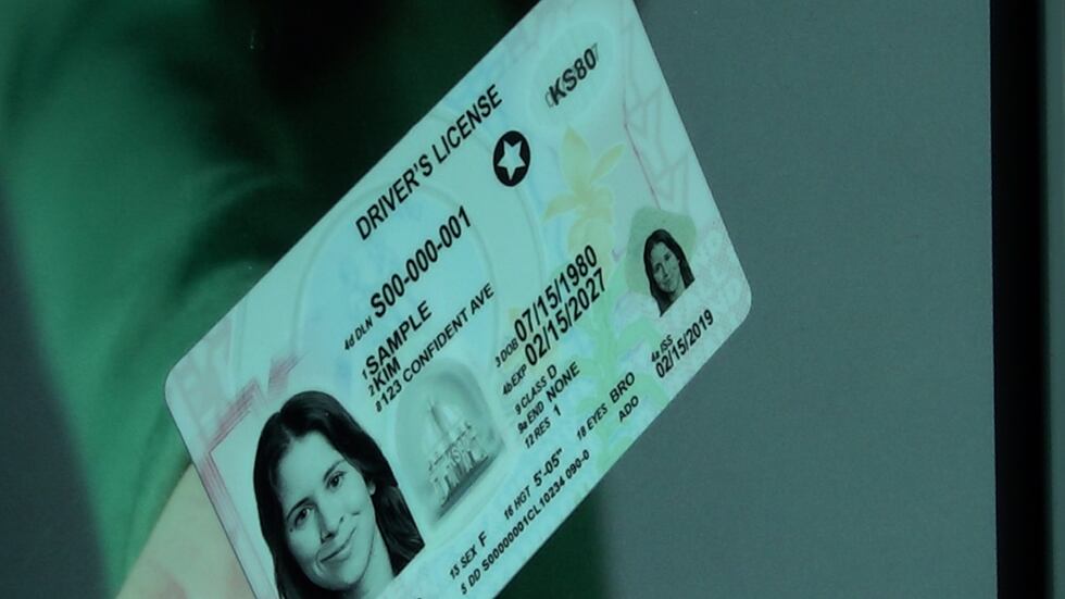 A photo of a sample Real ID-compliant driver's license on a poster at Ronald Reagan Washington...