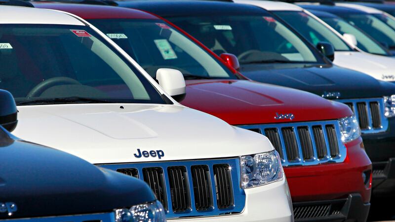 FILE - In this Nov. 30, 2010, file photo, a row of 2011 Jeep Grand Cherokee's sit at a...