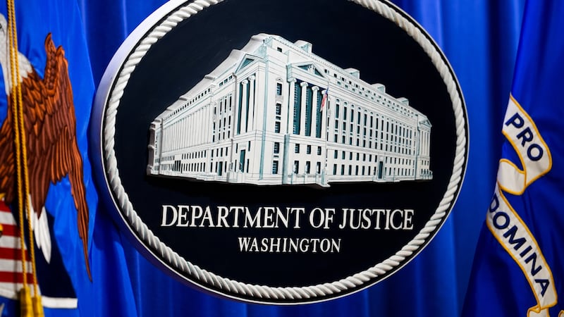 The U.S. Department of Justice logo is before a news conference, Monday, May 4, 2026, in...