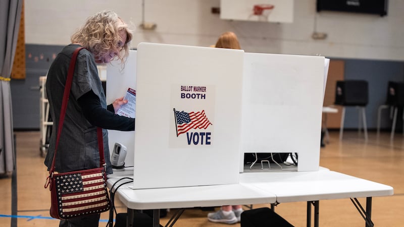 Marylou Zschach fills out her ballot at her polling place at the Burbank Early Childhood...